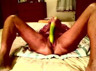 Freaky jamaican girl enjoys cucumber